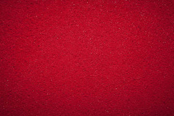 Background texture of solid red color made of soil.