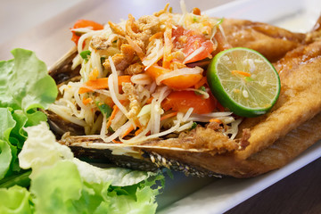 papaya salad with fried fish Thai cuisine spicy delicious