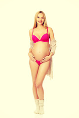 Obraz premium Pregnant woman in lingerie and socks