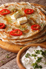Indian food: hot paratha with butter close-up. vertical
