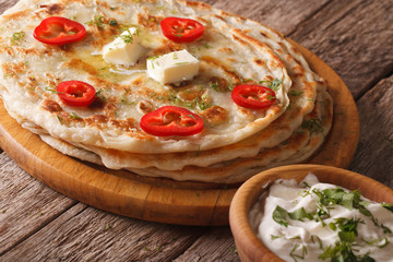 Indian paratha hot with butter and herbs closeup. horizontal
