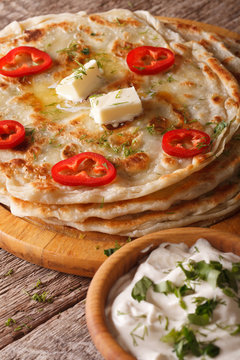 Indian food: hot paratha with butter close-up. vertical
