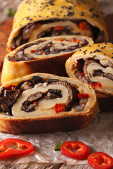 Strudel stuffed with wild mushrooms close-up on a board. vertical
