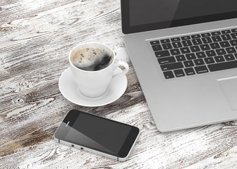 Laptop smartphone and coffee cup on wood table