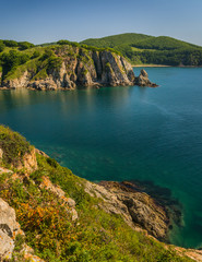 Obraz premium Rocks and mountains on the shores of the sea of Japan. Primorye, Russia. Скалы и горы на берегах Японского моря. Приморье, Россия