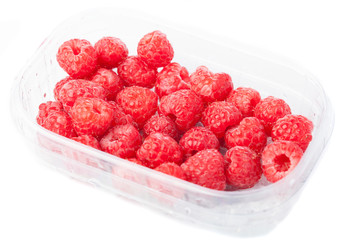 raspberries in a plastic  tray isolated on a white background