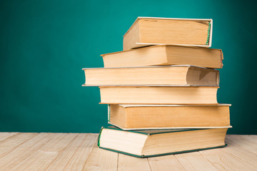 A stack of books on wooden table