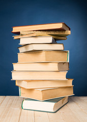 A stack of books on wooden table