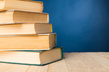 A stack of books on wooden table