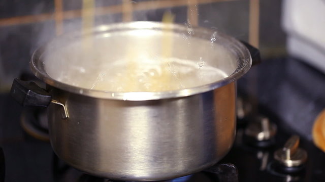 uncooked pasta thrown in boiling water