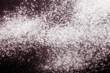 Flour spilling on monophonic background. Selective focus. Toned