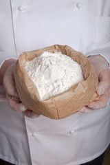 Flour in the womans hand. Selective focus