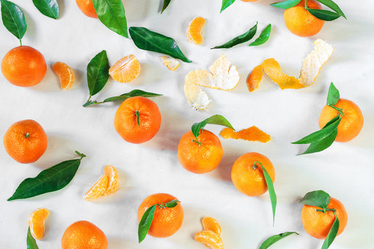 Tangerines on white tablecloth