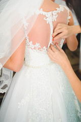 Obraz na płótnie Canvas Buttoning Wedding Dress