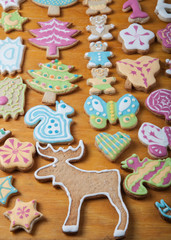Gingerbread homemade cookies with icing colored drawings on wood