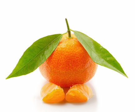 Tangerine with leaves and slices isolated on white background