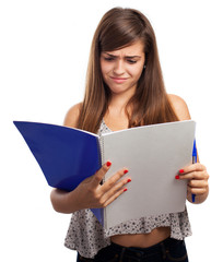 young girl annoyed holding a notebook isolated on white