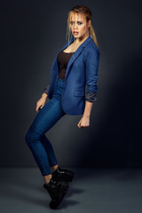 High fashion photo. Young beautiful model in trendy jacket and j