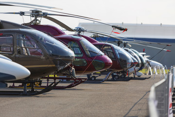 Helicopters lined up on the runway next to each other during the exhibition. No logos. © murmakova