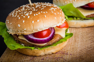 Big hamburger on kitchen board