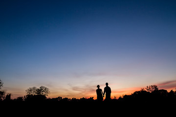 Couple in love walking at sunset.