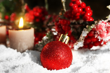 Naklejka na ściany i meble Burning candles and rowan with snow on wooden background, closeup