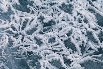 Texture of spring ice on Lake Baikal. Bubbles destruction ice after warming. Natural background