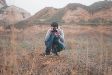 Young boy shooting with vintage camera