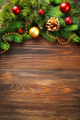 Christmas fir tree branches with toys on wooden table