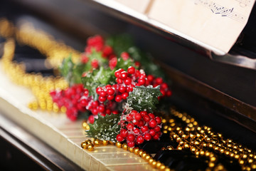 Piano keys decorated with Christmas decorations, close up