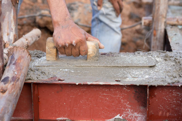 plasterer concrete worker at beam being constructed