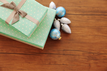 Box with Christmas toys on wooden background