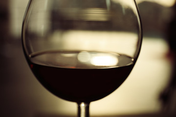 Glass of red wine on blurred background