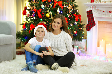 Mother with son near Christmas tree