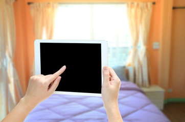 women hand holding the phone tablet on blurry room background