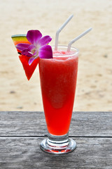 Glass of watermelon fresh juice on beach