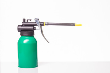 green oil can on white background