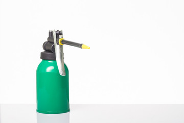 green oil can on white background