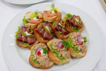 Delicious canapes with tuna, ham, smoke salmon and vegetable on toasted bread