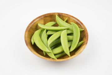 Green peas in bowl on white background