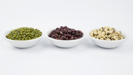 Black eye peas, mung bean and adzuki beans in white bowl on white background