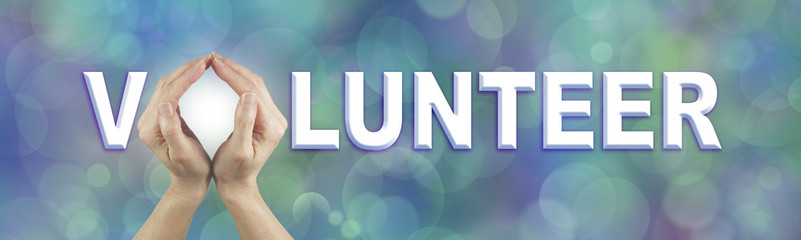 Volunteer Request Website Banner  - Female using both hands to make an O in the word VOLUNTEER on a...
