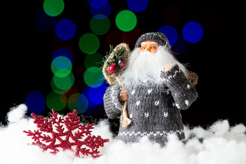 Obraz premium Santa Claus with bag of presents on the black background