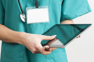 Female doctor at hospital working on a digital tablet 