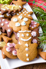 Colorful Christmas gingerbread cookies on wooden background