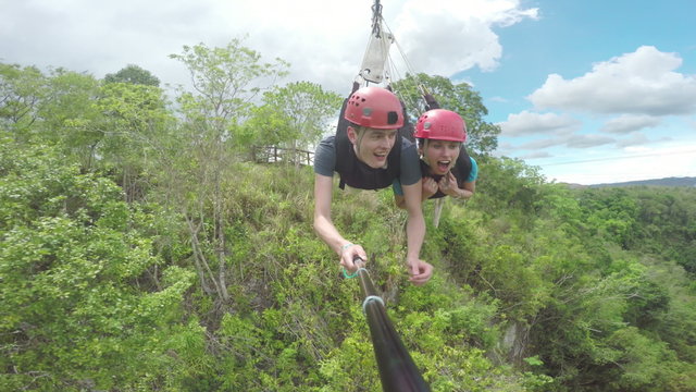 Stunning footage of a couple sliding down a zipline, zip-line, thy are quite shocked when they leave the forest and fly over the canyon. Part one, filmed of a selfiestick. 
