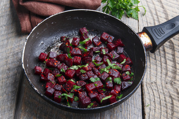 Cooked beets sliced and fried in a pan