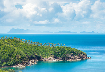 Beautiful green peninsula with palm trees in the sea on Koh Phangan, Thailand