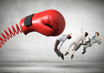 Businesspeople fighting with boxing glove