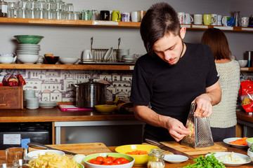 young couple cooking on kitchen